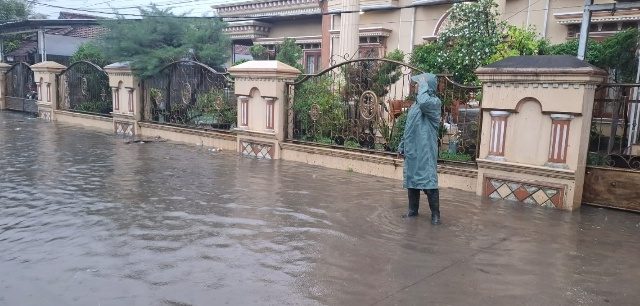 Babinsa Pelda Putu Turun Langsung Mantau Genangan Air Dan Pastikan Keselamatan Warga
